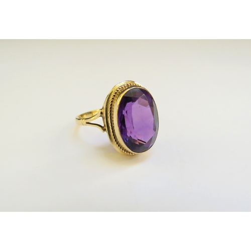 9172 - A 9ct gold ring with oval amethyst. Size N, 3.3g