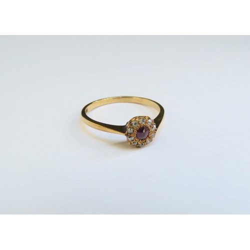 9296 - A ruby and old cut diamond daisy ring, stamped 18ct. Size N/O, 2.1g