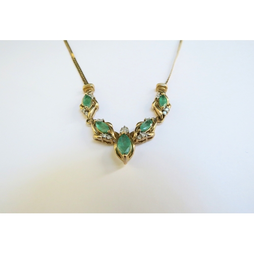 9295 - A 9ct gold emerald and diamond necklace, the five marquise shape emeralds studded with diamond to mo... 