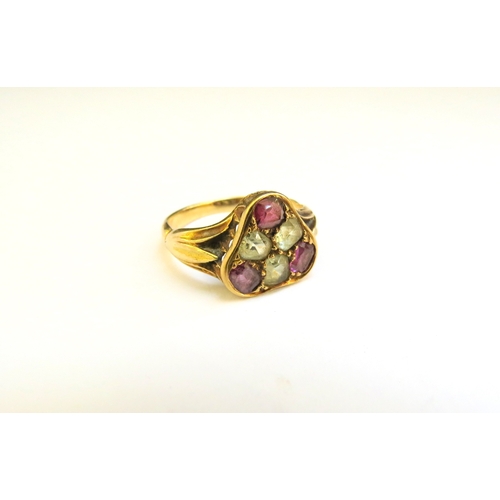 9169 - An unmarked gold ring with three pink and three pale yellow stones in triangle mount. Size P/Q, 3.8g