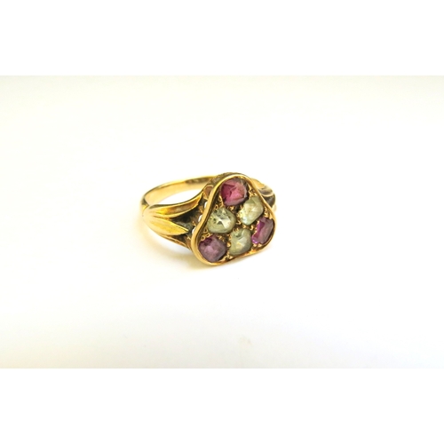 9169 - An unmarked gold ring with three pink and three pale yellow stones in triangle mount. Size P/Q, 3.8g