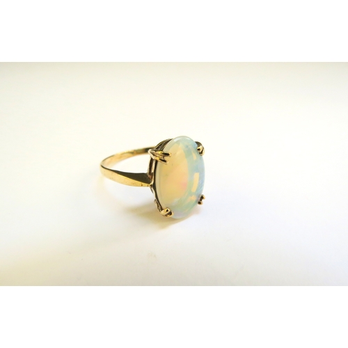 9208 - A 9ct gold oval opal ring. Size Q/R, 2.5g