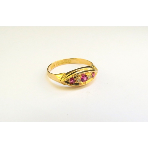 9309 - An 18ct gold ring set with three pink stone spaced by diamonds. Size O, 2.4g  (C)