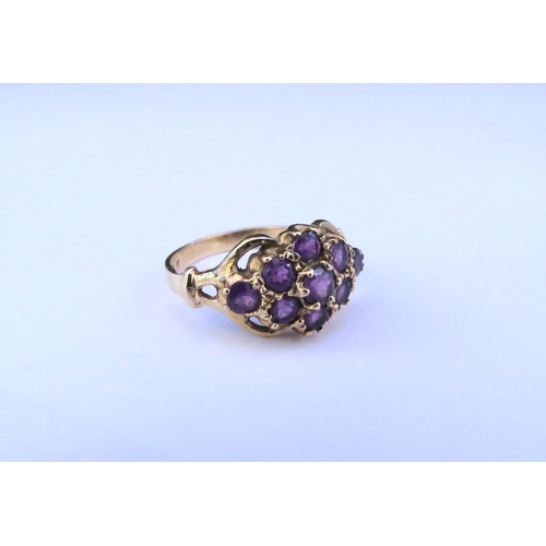 9330 - A 9ct gold amethyst cluster ring. Size L/M, 2.9g