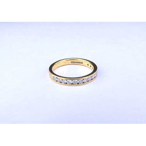 9150 - An 18ct gold half hoop diamond ring in channel setting. Size M/N, 3g  (C)