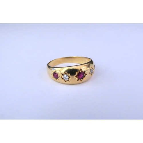 9250 - A gold gypsy ring with three rubies and two diamonds in star settings, stamped 18ct. Size P/Q, 5.4g