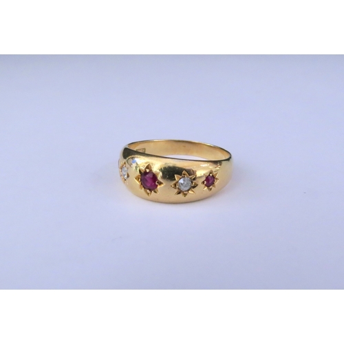 9250 - A gold gypsy ring with three rubies and two diamonds in star settings, stamped 18ct. Size P/Q, 5.4g