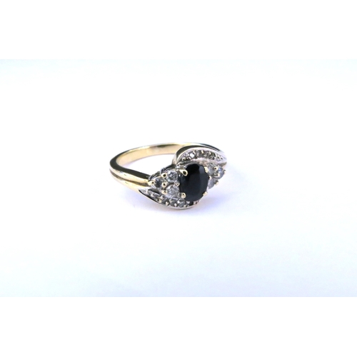 9189 - A 9ct gold sapphire and diamond crossover ring. Size L/M, 2.6