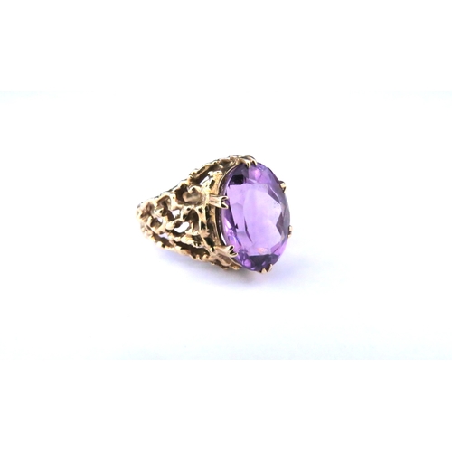 9251 - A 9ct gold openwork textured ring with a large oval amethyst. Size P, 6.1g