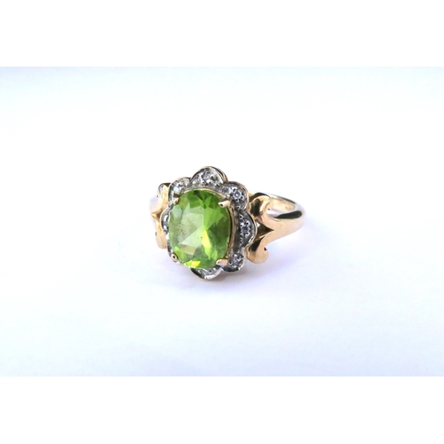 9149 - A 9ct gold peridot and diamond ring, the central oval peridot framed by diamond chips. Size N/O, 3.9... 