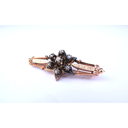 9220 - An unmarked gold brooch with six point star to centre set with seven old cut diamonds 5.5cm long, 5.... 