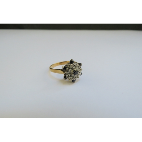 9339 - A 9ct gold sapphire and diamond chip cluster ring. Size L/M, 2.8g