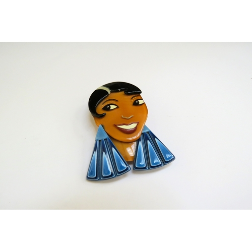 9373 - A Lea Stein brooch as a female with large blue earrings