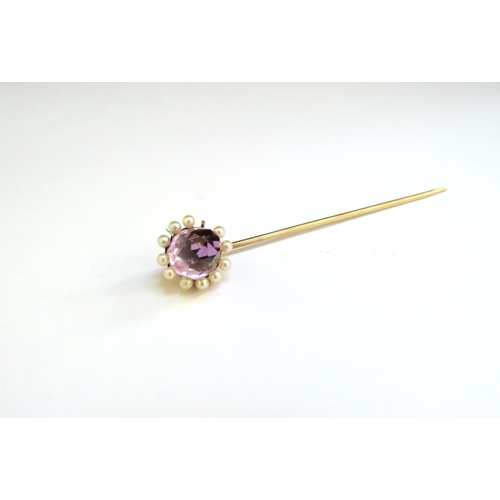 9366 - An unmarked gold amethyst and pearl stick pin, one pearl missing, 3.8g