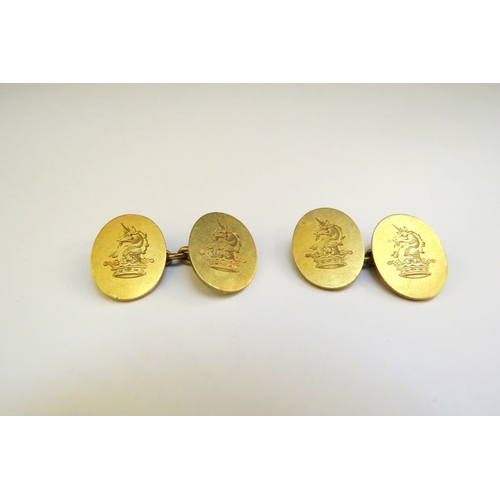 9269 - A pair of gold cufflinks, oval form with unicorn and crown engraved design, stamped 18ct, 12.8g