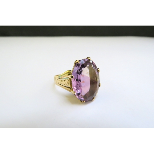 9304 - A gold ring set with an oval amethyst. Size P/Q, 5.9g