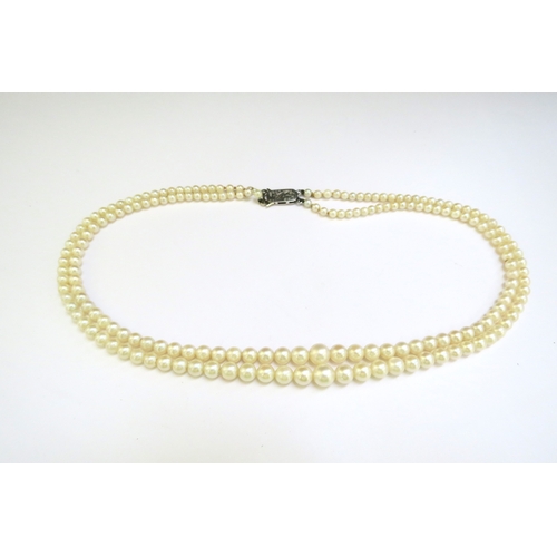 9374 - A double strand cultured pearl necklace, circa 1930, clasp stamped 9ct, 46cm long, boxed