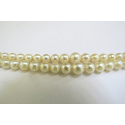 9374 - A double strand cultured pearl necklace, circa 1930, clasp stamped 9ct, 46cm long, boxed