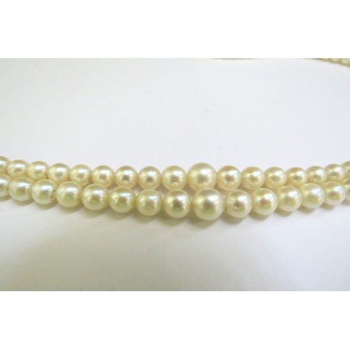 9374 - A double strand cultured pearl necklace, circa 1930, clasp stamped 9ct, 46cm long, boxed