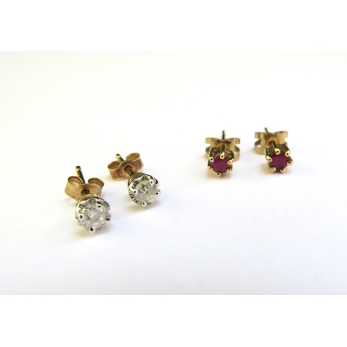 9319 - A pair of diamond studs and a pair of ruby stud earrings