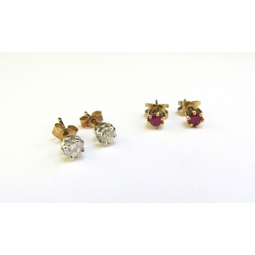 9319 - A pair of diamond studs and a pair of ruby stud earrings