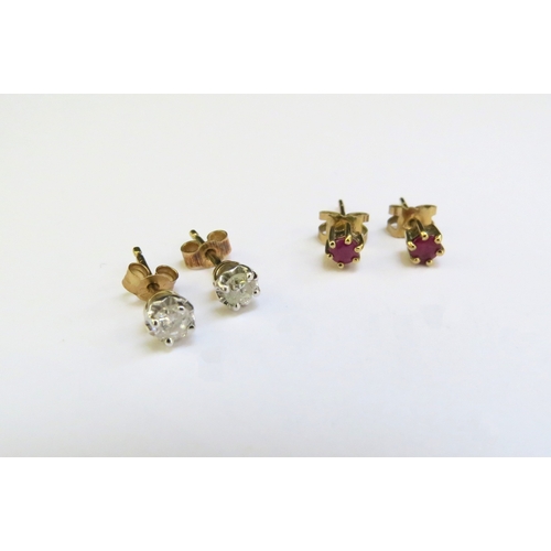 9319 - A pair of diamond studs and a pair of ruby stud earrings