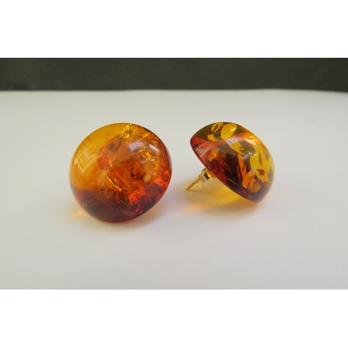 9367 - A pair of domed circular amber earrings, 2.4cm diameter