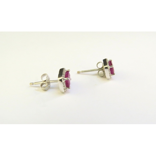 9013 - A pair of 18ct white gold ruby and diamond earrings