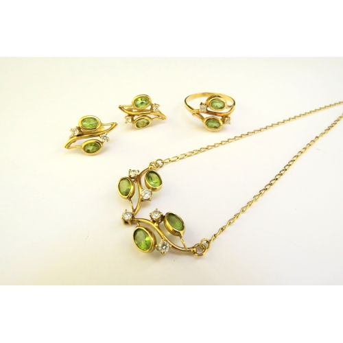 9181 - A suite of peridot jewellery consisting of earrings, ring, size Q and necklace, all stamped 750, 10.... 