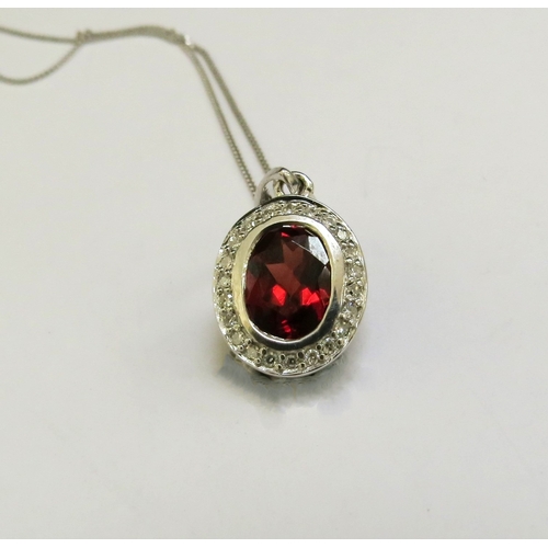 9162 - A white gold garnet and diamond cluster pendant hung on 9ct white gold chain, 46cm long, 2.4g