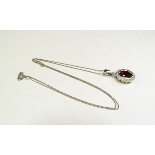 9162 - A white gold garnet and diamond cluster pendant hung on 9ct white gold chain, 46cm long, 2.4g