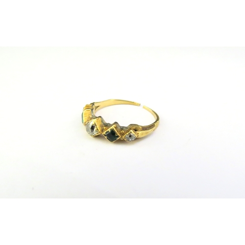 9341 - A gold ring set with two emeralds and three diamonds, shank worn, split and repair present. Size L, ... 