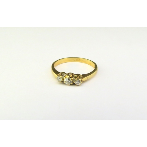 9352 - A three stone diamond ring, stamped 18ct. Size O, 2.8g