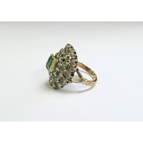 9140 - An emerald and diamond cluster ring, the central emerald 5mm x 8mm framed by diamonds 2ct approx tot... 