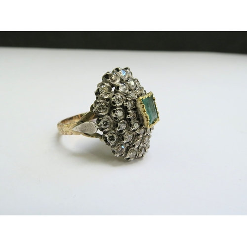 9140 - An emerald and diamond cluster ring, the central emerald 5mm x 8mm framed by diamonds 2ct approx tot... 