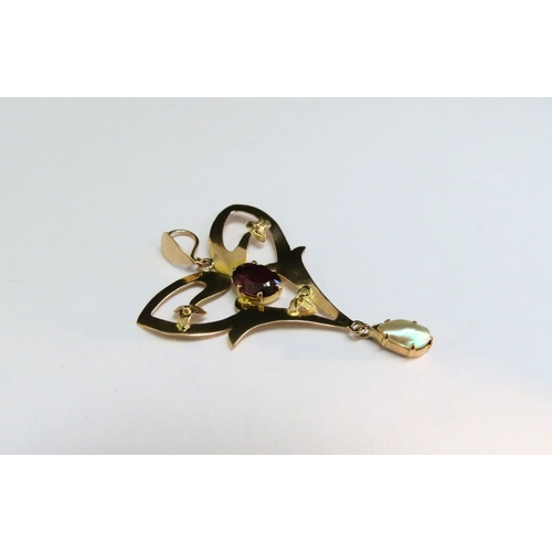 9119 - An Edwardian gold pendant with garnet and pearl drop, stamped 9ct, 106g