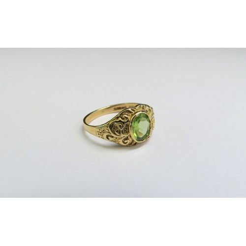 9073 - A 9ct gold ring set with an oval peridot in ornate scroll mount. Size I, 1.9g