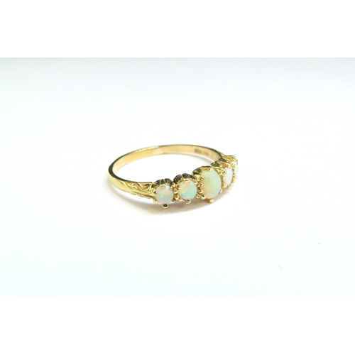 9098 - A 9ct gold five stone opal ring. Size S, 2.2g