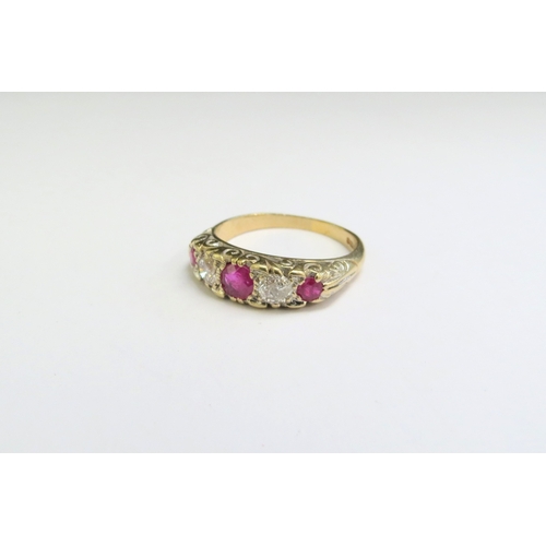 9003 - A 9ct gold ruby and diamond five stone ring. Size U, 4.7g