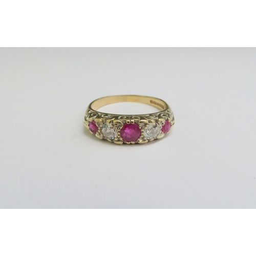 9003 - A 9ct gold ruby and diamond five stone ring. Size U, 4.7g