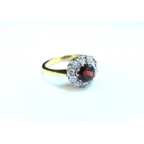 9030 - An 18ct gold garnet and diamond cluster ring. Size N/O, 4.1g  (C)