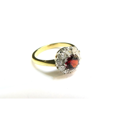 9030 - An 18ct gold garnet and diamond cluster ring. Size N/O, 4.1g  (C)