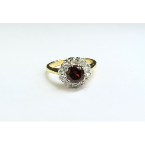 9030 - An 18ct gold garnet and diamond cluster ring. Size N/O, 4.1g  (C)