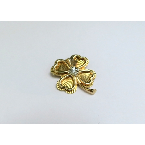 9078 - A gold brooch as a four leaf clover with diamond to centre, stamped 14k, 7.1g