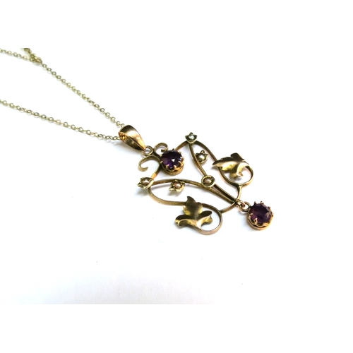 9066 - A gold chain stamped 9kt, 40cm long hung with a gold pendant with seed pearl and amethyst coloured s... 