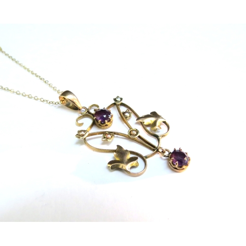 9066 - A gold chain stamped 9kt, 40cm long hung with a gold pendant with seed pearl and amethyst coloured s... 