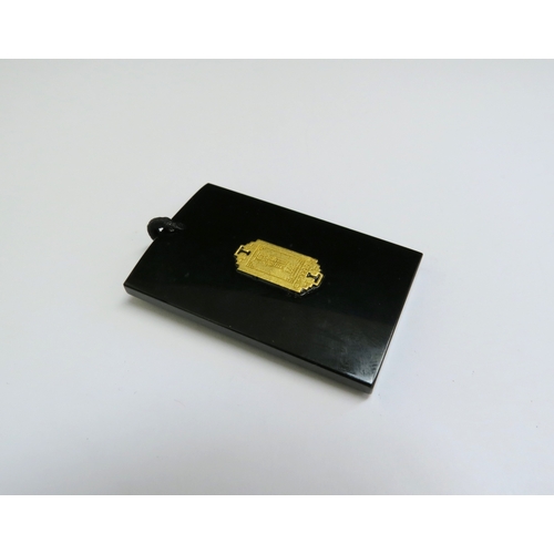 9044 - A black jade pendant of rectangular form, inset with 999.9 gold dragon, 4.5cm x 2.8cm