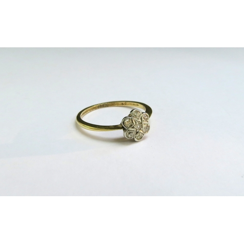 9023 - A diamond daisy ring, stamped 18ct. Size P, 2g