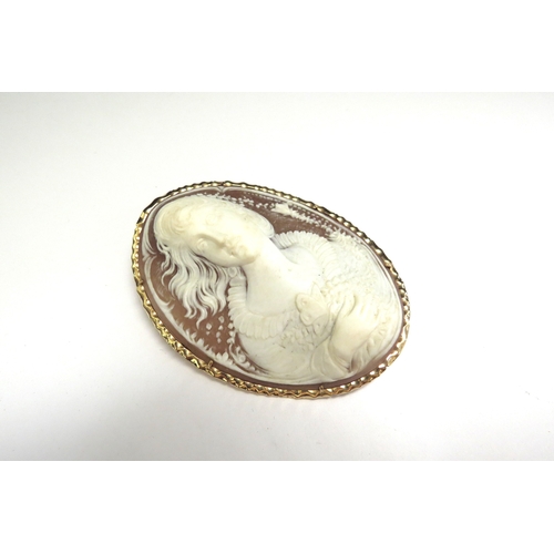 9070 - A finely carved shell cameo brooch depicting bust length image of female holding flower, stamped 14k... 