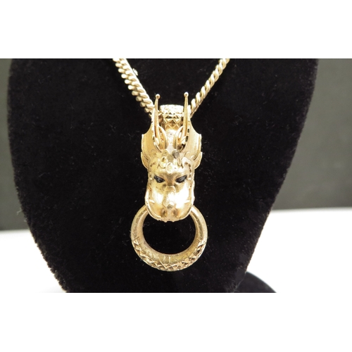 9058 - A gold Bali dragon pendant, bale stamped 9k, hung on chain stamped 375, 50cm long, 14.3g  (R)  £250